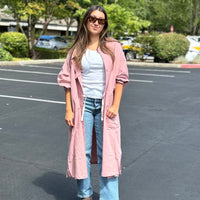 Model wearing 2-way smock-inspired tunic coat with buttons in front, styled open for a relaxed, casual look