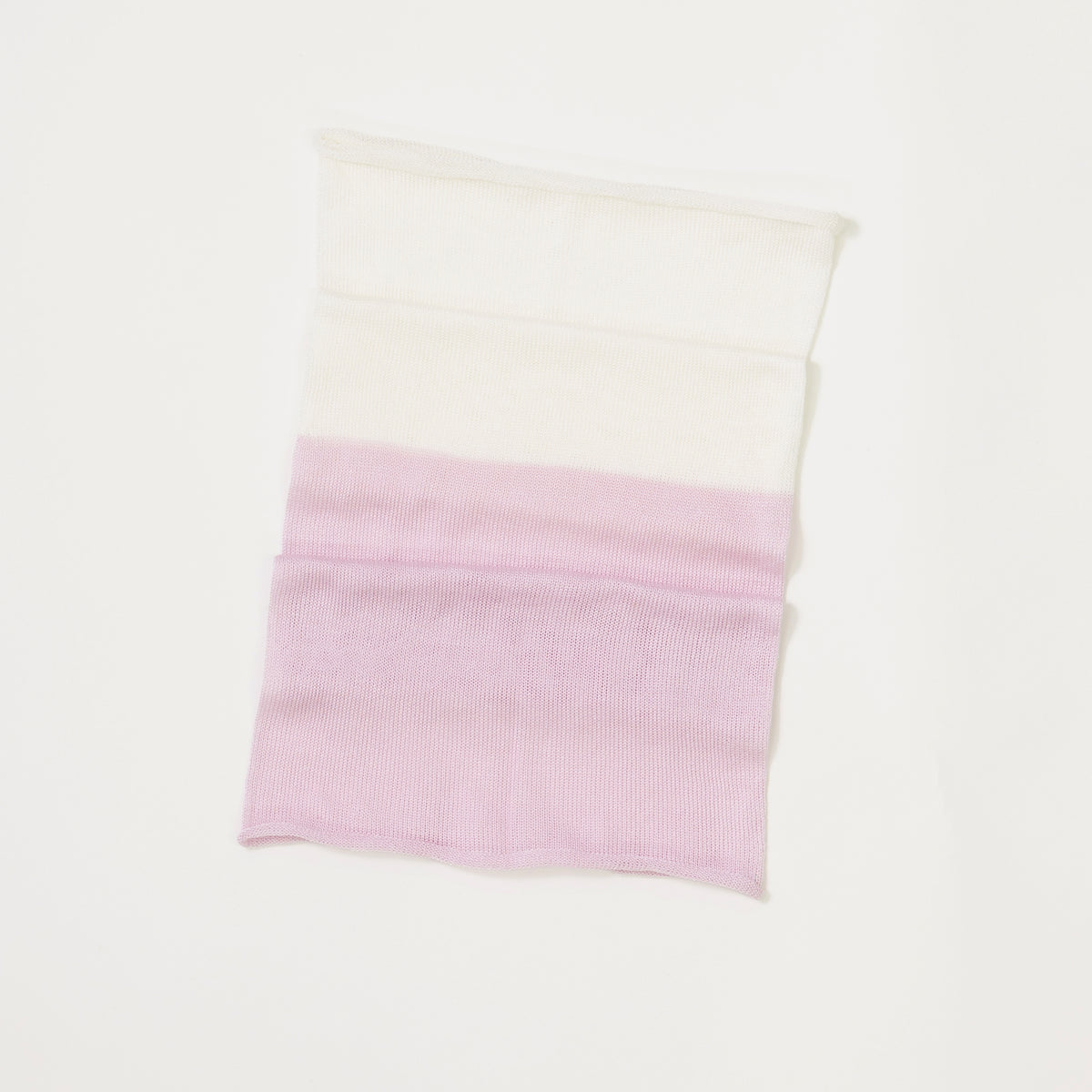 Two-toned lilac and white pillow on a white background