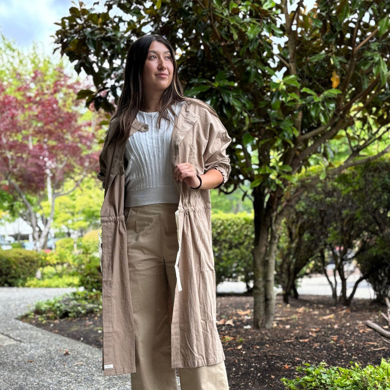 Model wearing 2-way smock-inspired tunic coat with buttons in front, styled open for a relaxed, casual look.