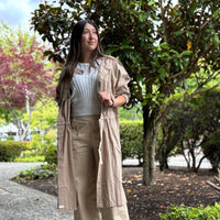 Model wearing 2-way smock-inspired tunic coat with buttons in front, styled open for a relaxed, casual look.