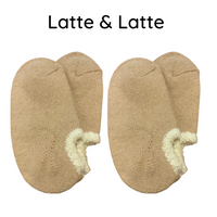 Airy Grace Organic Cotton Slipper Socks with Fuzzy Trim. Moisture-absorbing and heat-retaining properties. Undyed in a natural color, featuring a cozy, double-knit ribbed 