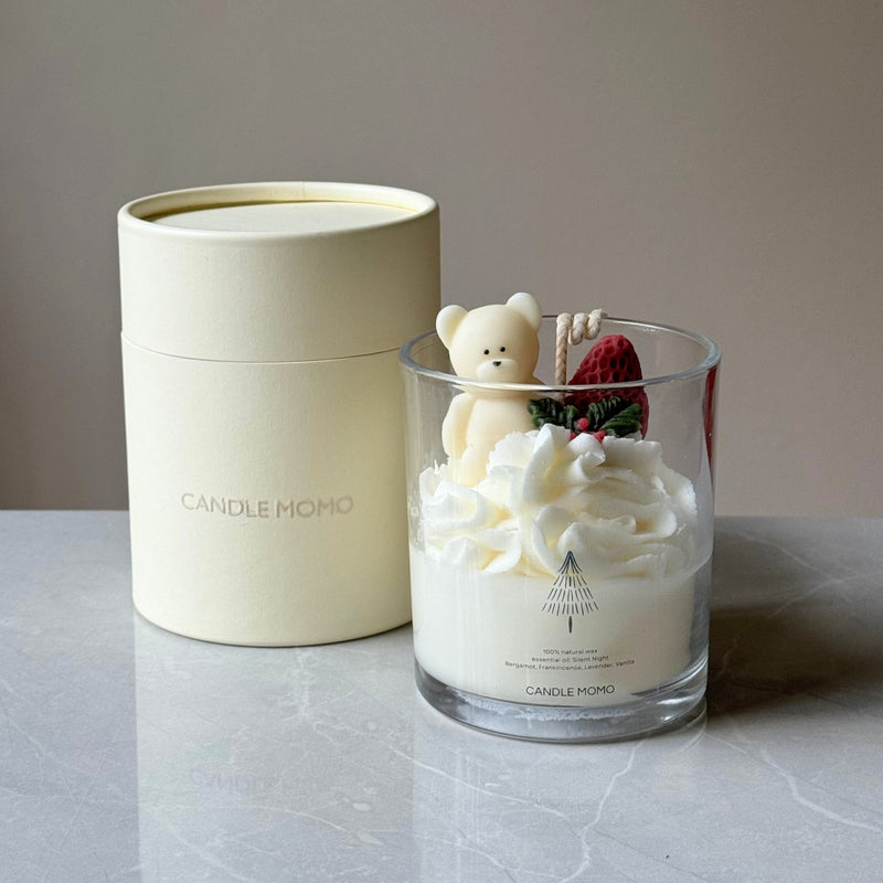 CANDLE MOMO glass candle with a bear figurine and strawberry on a neutral background