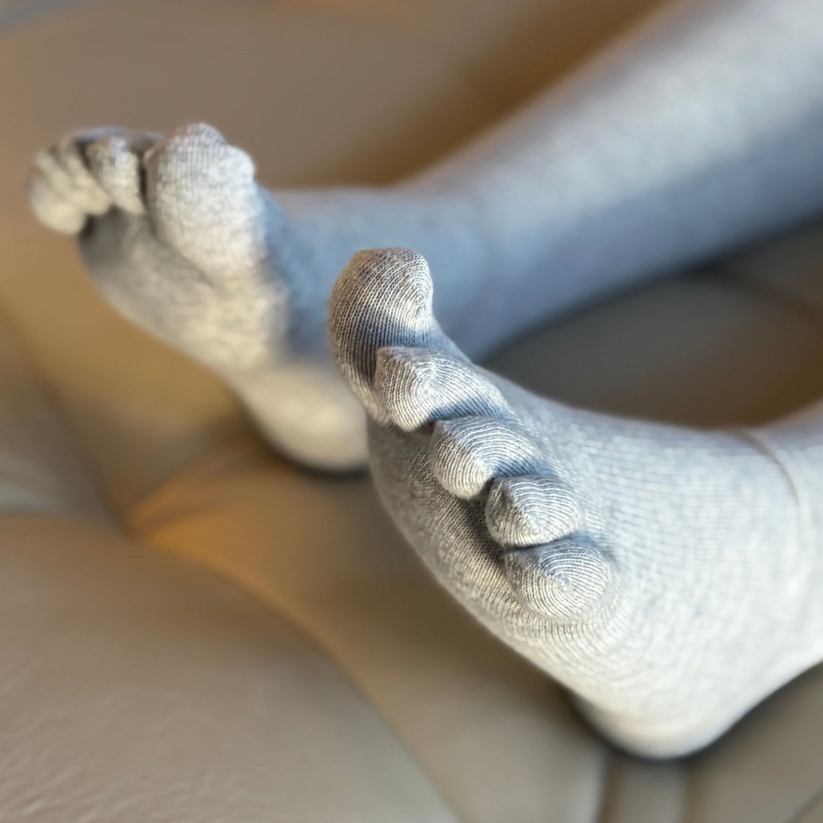 Close-up of feet wearing white socks on a blurred background