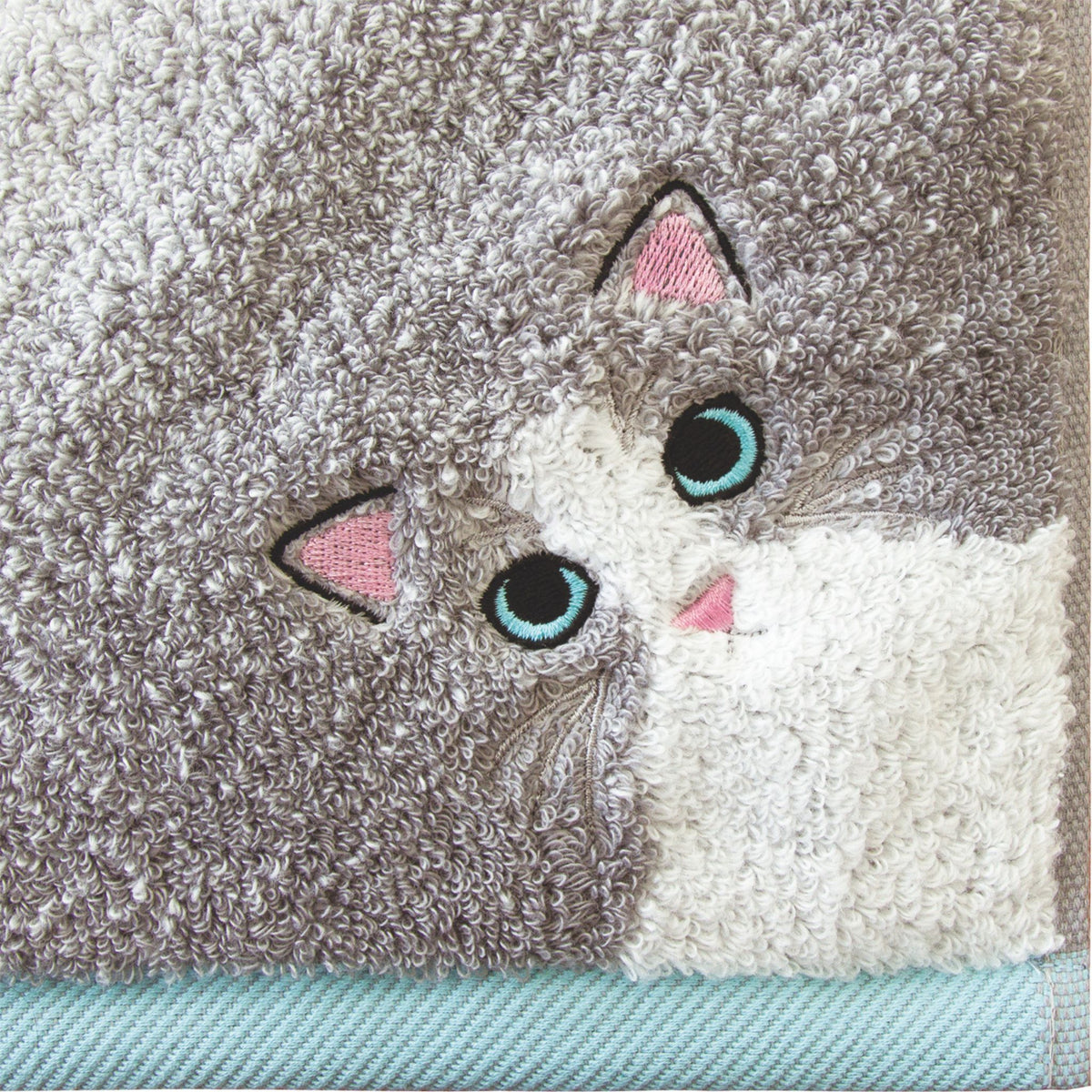 Textured towel with cat face design.