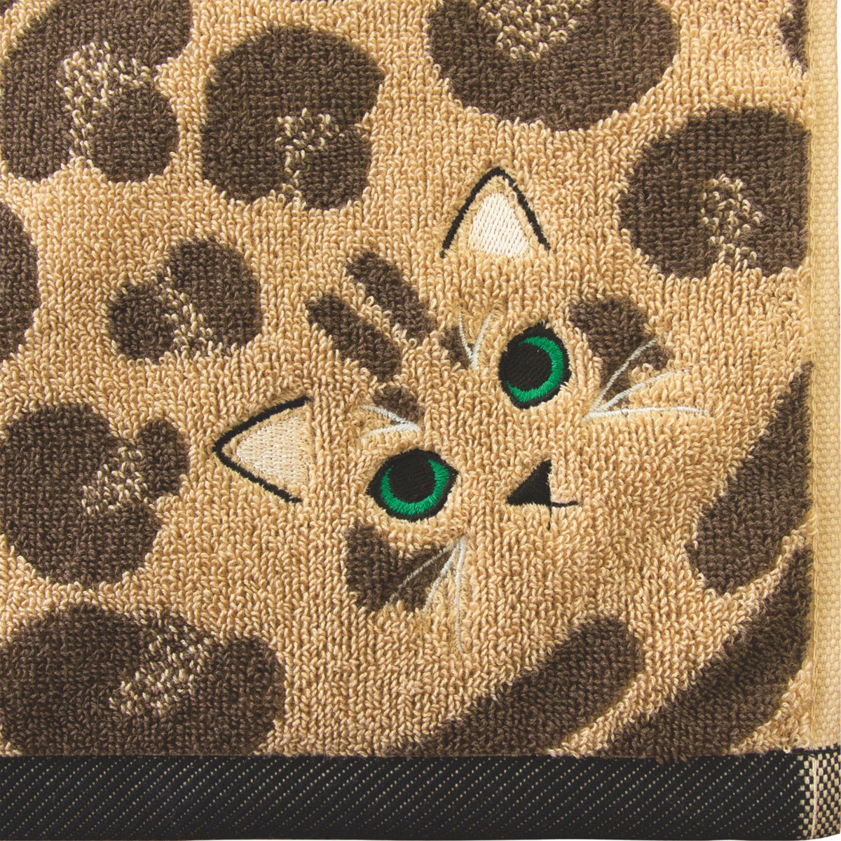 Close-up of a textured surface with a cat face design and leopard print pattern.