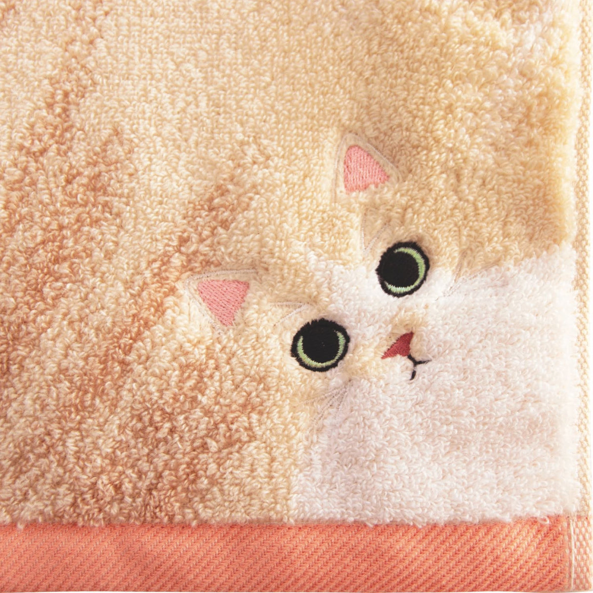 Cute cat face design on a textured towel background