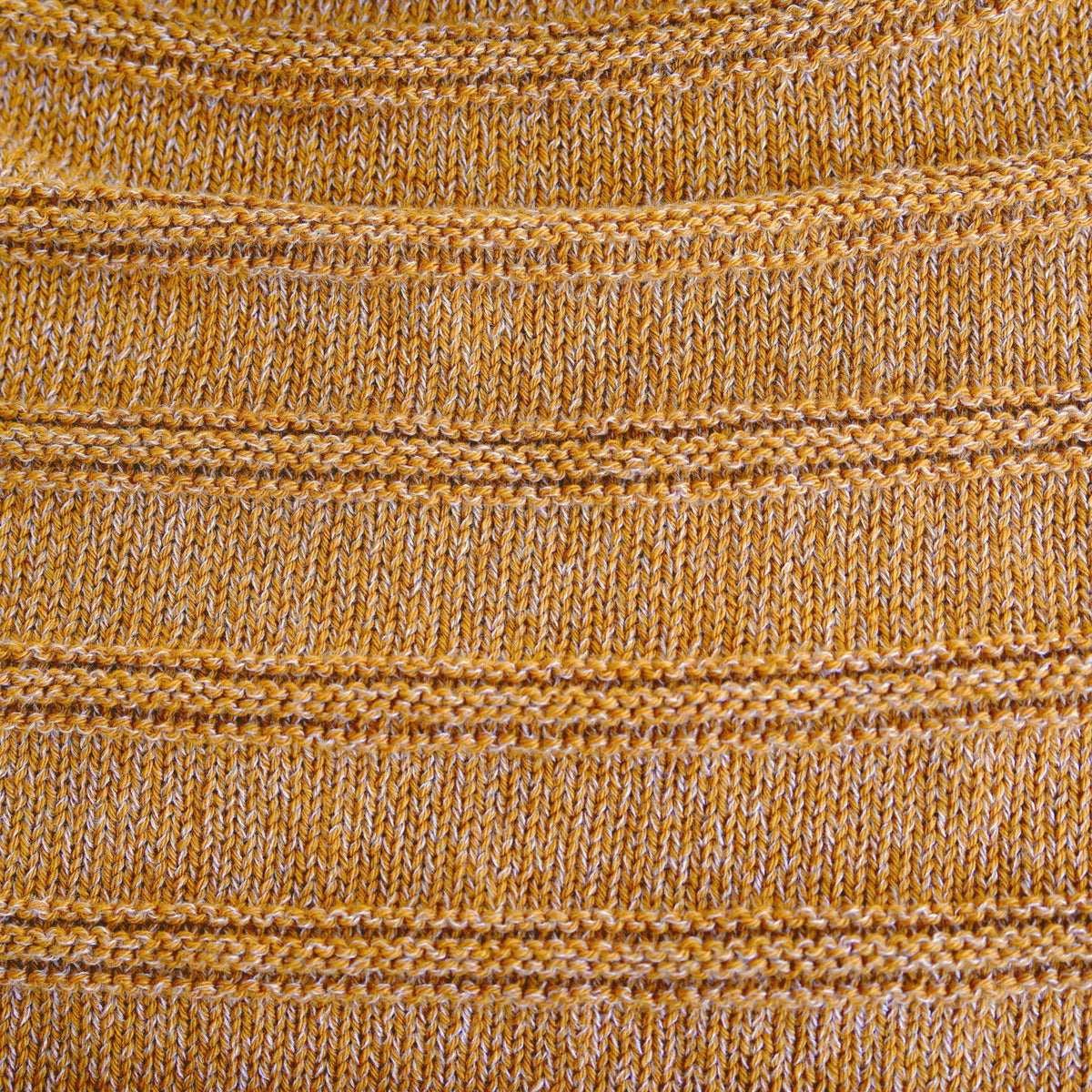 mustard knit benie on a white background