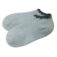 Angora Slipper Socks with anti-slip soles featuring transparent grip dots for extra safety. Each pair is handcrafted, incorporating traditional craftsmanship, and finished with cherrystone shell-shaped embroidery on the sock opening. Soft, cozy, and comfortable for ultimate foot pampering.