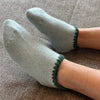 Women wearing - Handcrafted Angora Slipper Socks Grips. Aqua, Light Blue with Green colored trim. Blend with Merino Wool. Size:Unisex Large (US women's shoe size 9 and up,  US men's shoe size 8.5-11.5)-CHERRYSTONEstyle