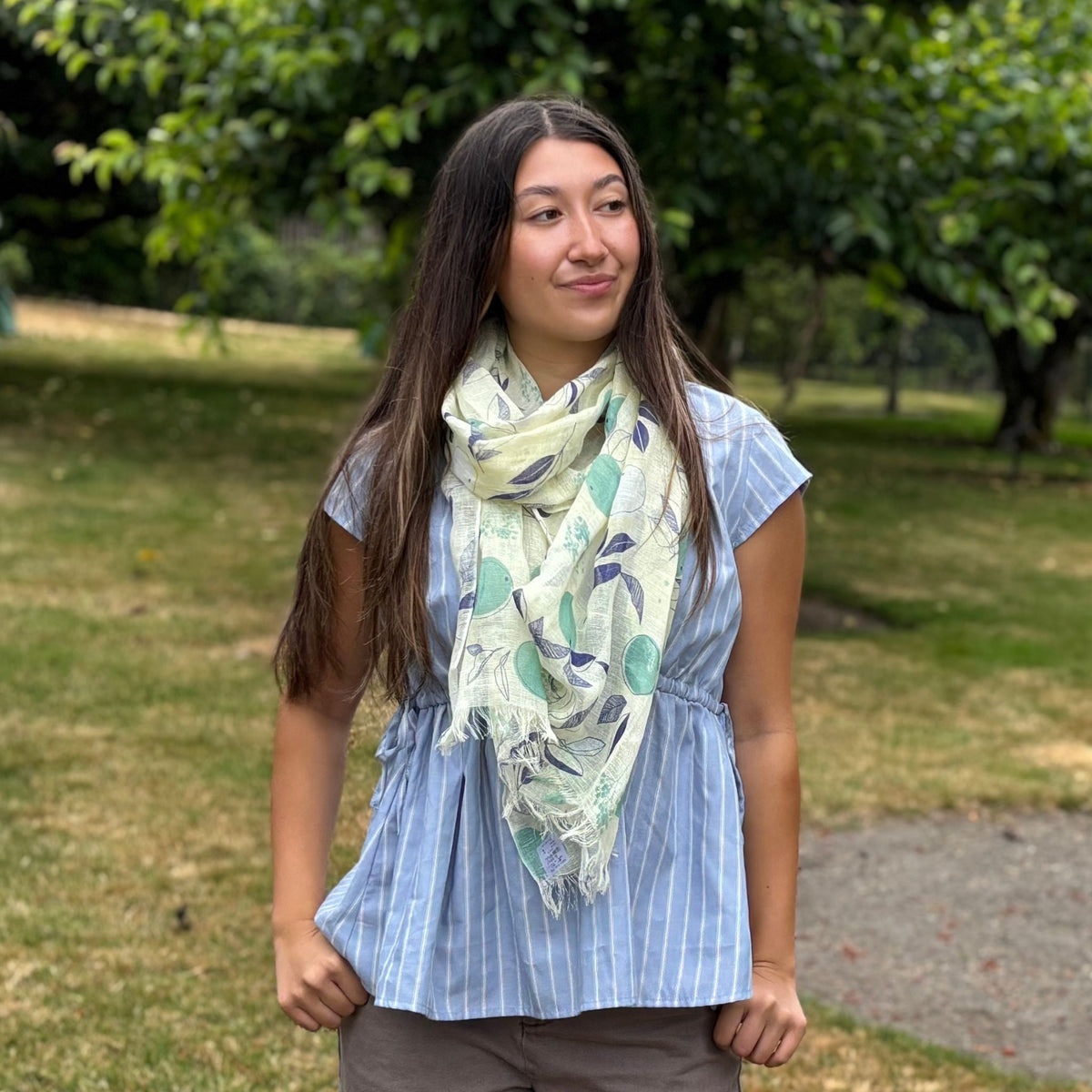 woman wearing a yellow summer scarf upf30 citrus design.