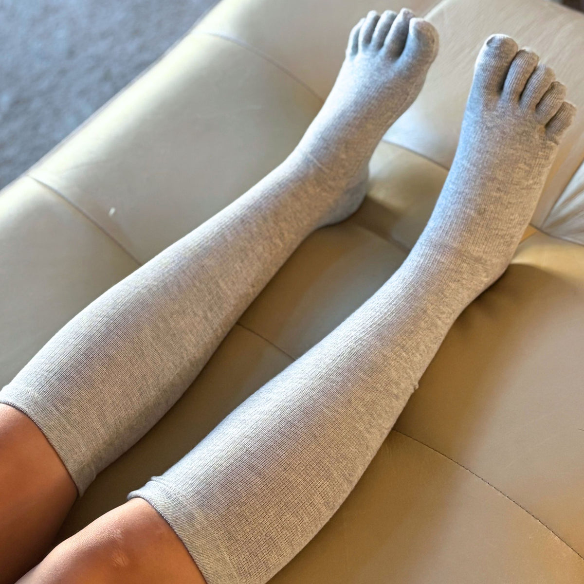 Gray socks with textured sole on a blurred background