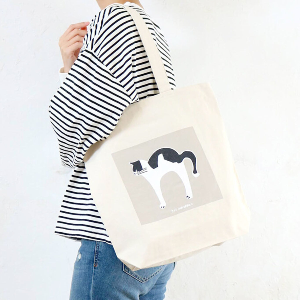 A tote bag with a graphic design on a white background