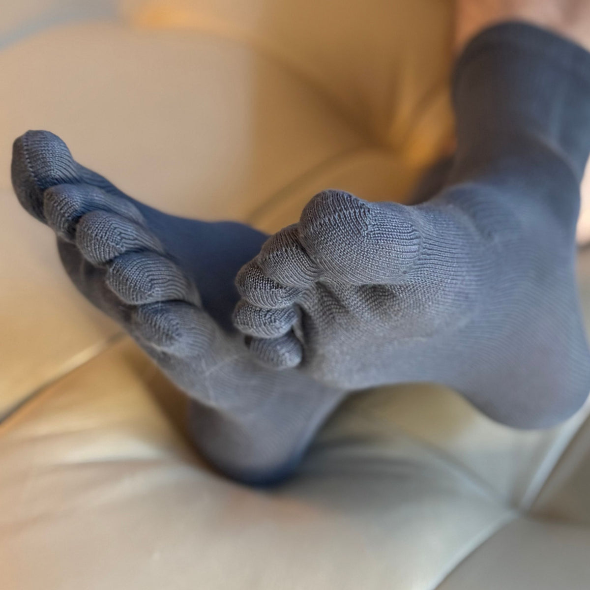Gray socks with textured sole on a blurred background