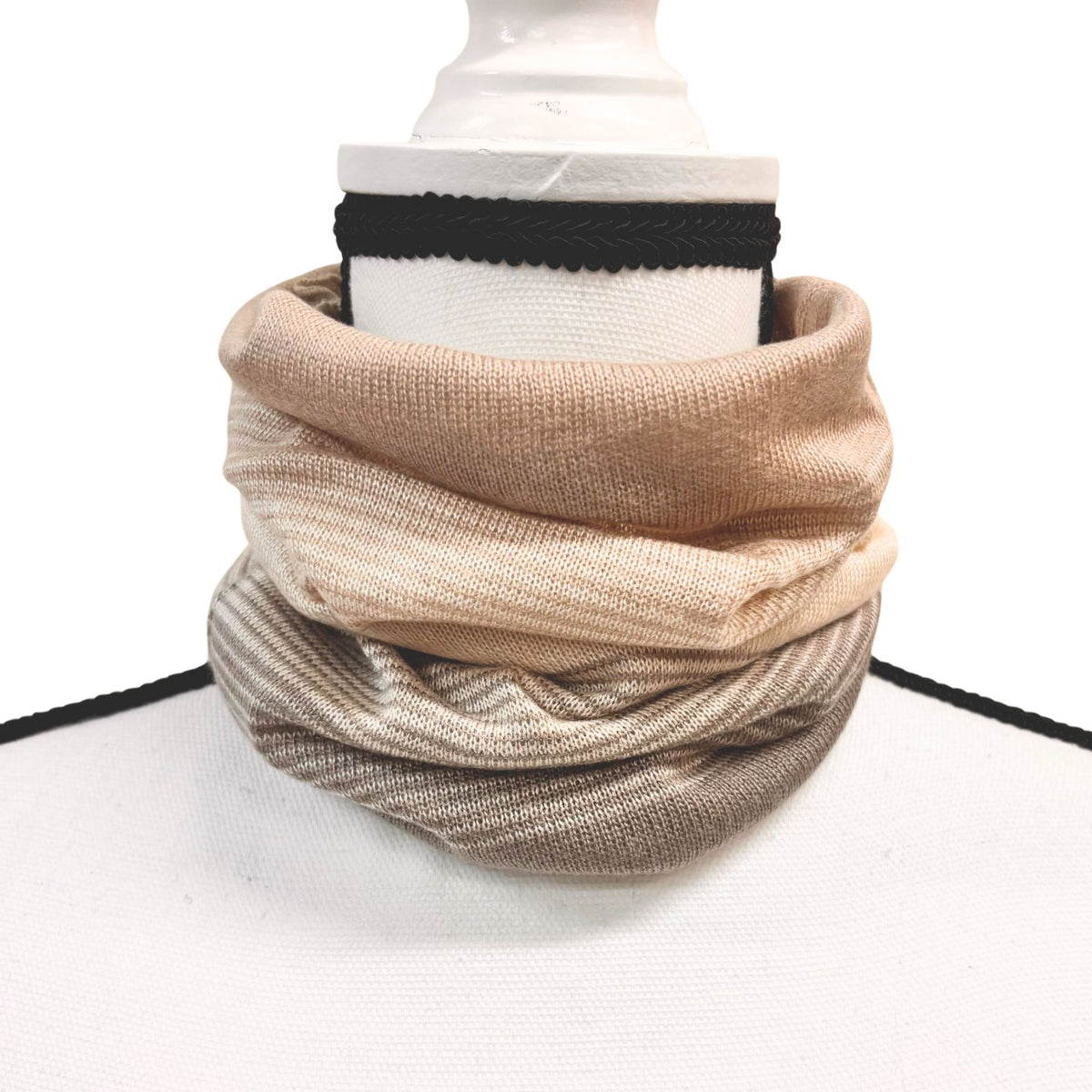 Beige scarf on a mannequin with a white background