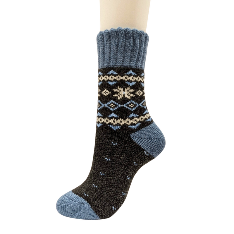 Warm Nordic Slipper Crew Socks made from a merino wool blend with thick ribbed cuffs to block cold air and a brushed lining for added cushioning. The soles feature invisible non-slip grips. Available in four stylish colors, perfect as a gift or for cozy days at home.