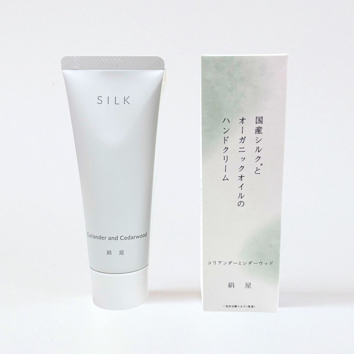 Silk hand cream tube and packaging on a white background