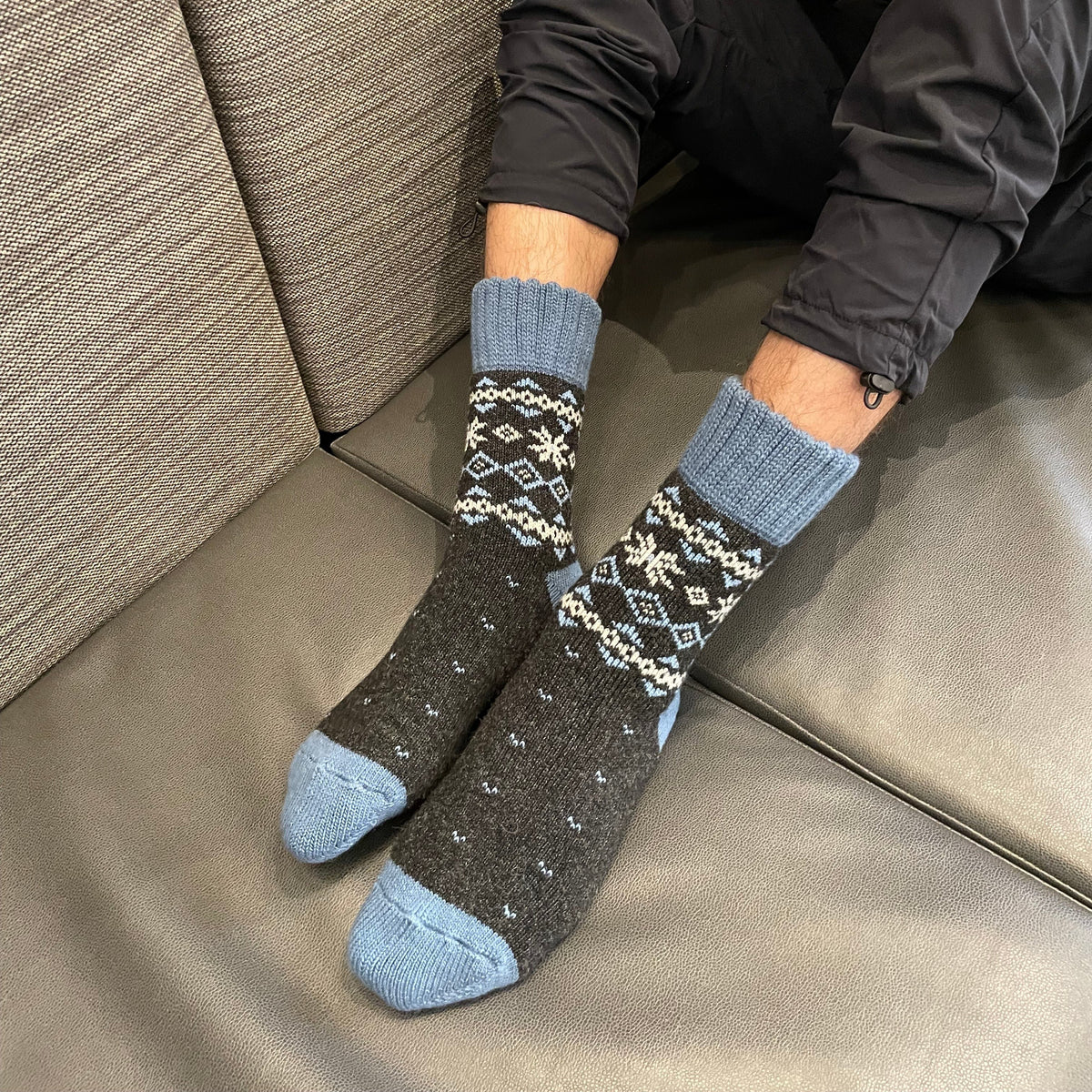 Warm Nordic Slipper Crew Socks made from a merino wool blend with thick ribbed cuffs to block cold air and a brushed lining for added cushioning. The soles feature invisible non-slip grips. Available in four stylish colors, perfect as a gift or for cozy days at home.