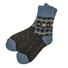 Warm Nordic Slipper Crew Socks made from a merino wool blend with thick ribbed cuffs to block cold air and a brushed lining for added cushioning. The soles feature invisible non-slip grips. Available in four stylish colors, perfect as a gift or for cozy days at home.