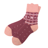 Warm Nordic Slipper Crew Socks made from a merino wool blend with thick ribbed cuffs to block cold air and a brushed lining for added cushioning. The soles feature invisible non-slip grips. Available in four stylish colors, perfect as a gift or for cozy days at home.