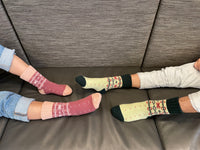 Warm Nordic Slipper Crew Socks made from a merino wool blend with thick ribbed cuffs to block cold air and a brushed lining for added cushioning. The soles feature invisible non-slip grips. Available in four stylish colors, perfect as a gift or for cozy days at home.