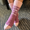 Warm Nordic Slipper Crew Socks made from a merino wool blend with thick ribbed cuffs to block cold air and a brushed lining for added cushioning. The soles feature invisible non-slip grips. Available in four stylish colors, perfect as a gift or for cozy days at home.