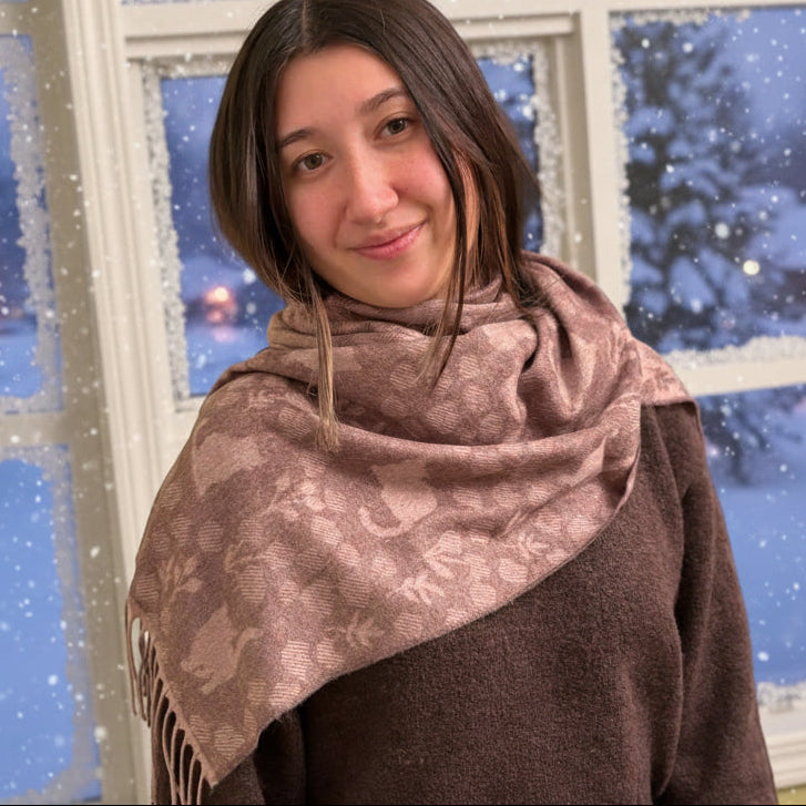 Person wearing a cat patterned scarf in an outdoor setting