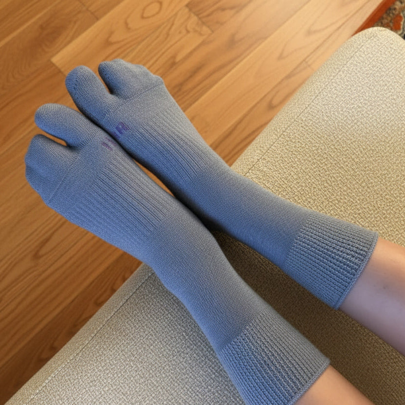 Gray tabi socks worn on a couchi