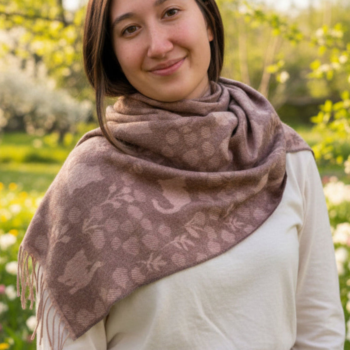 Woman wearing a patterned scarf in a garden setting