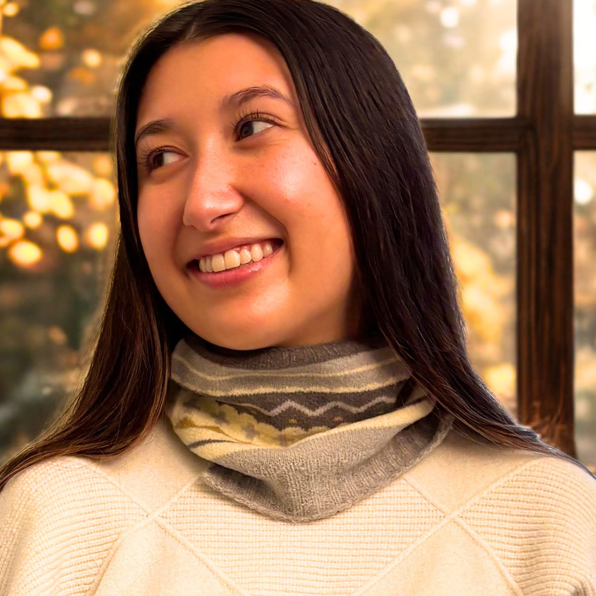 Woman wearing a patterned scarf with a blurred background