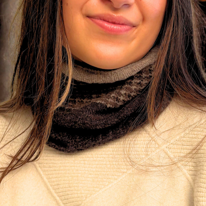 Woman wearing a dark charcoal scarf with a beige sweater