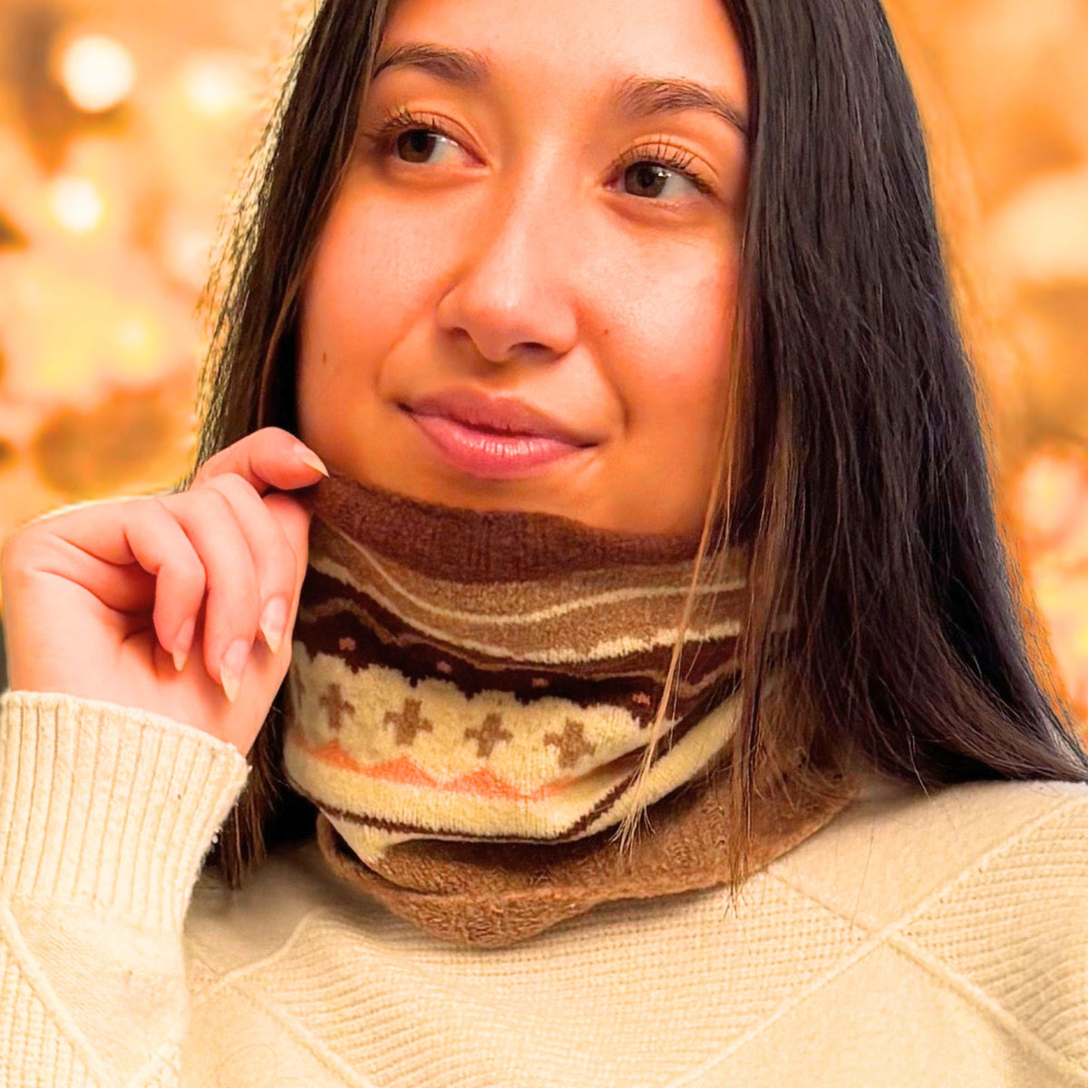 Woman wearing a patterned scarf with a blurred autumn background