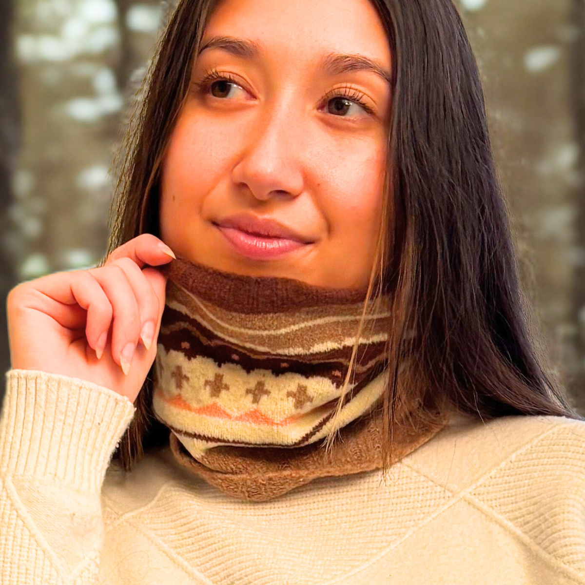 Woman wearing a silk blend neck warmer with a blurred natural background