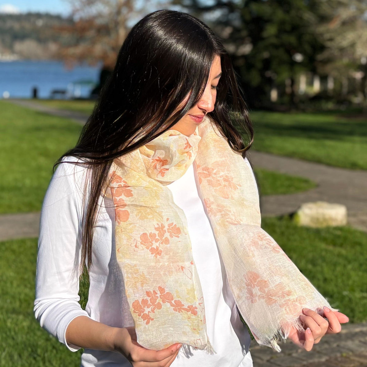 Woman wearing a floral scarf in a park setting