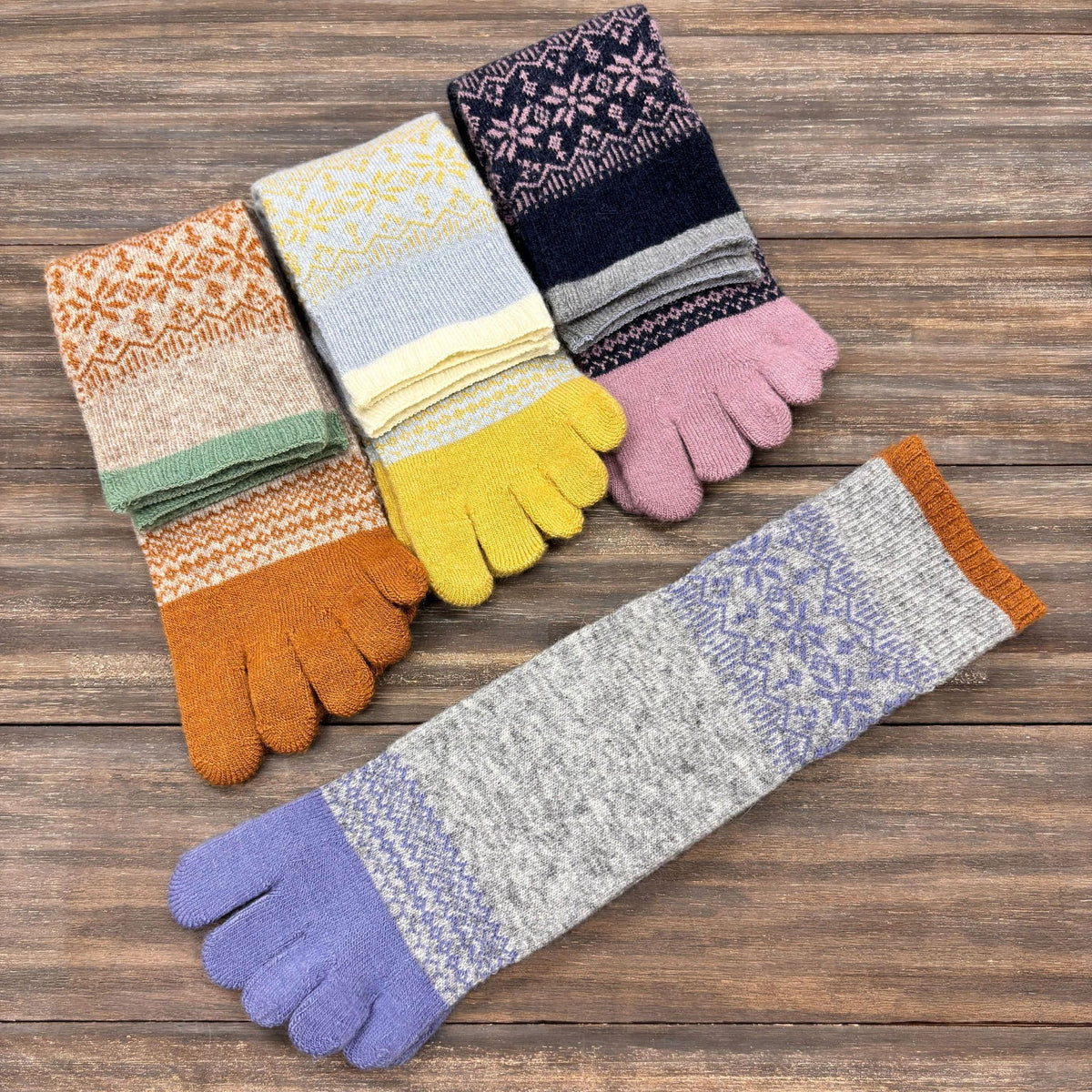 Set of colorful five toe socks on a wooden surface