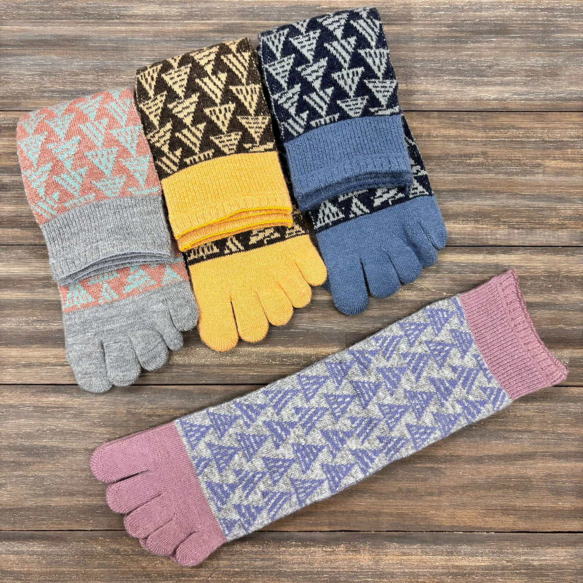 Set of patterned toe socks on a wooden surface