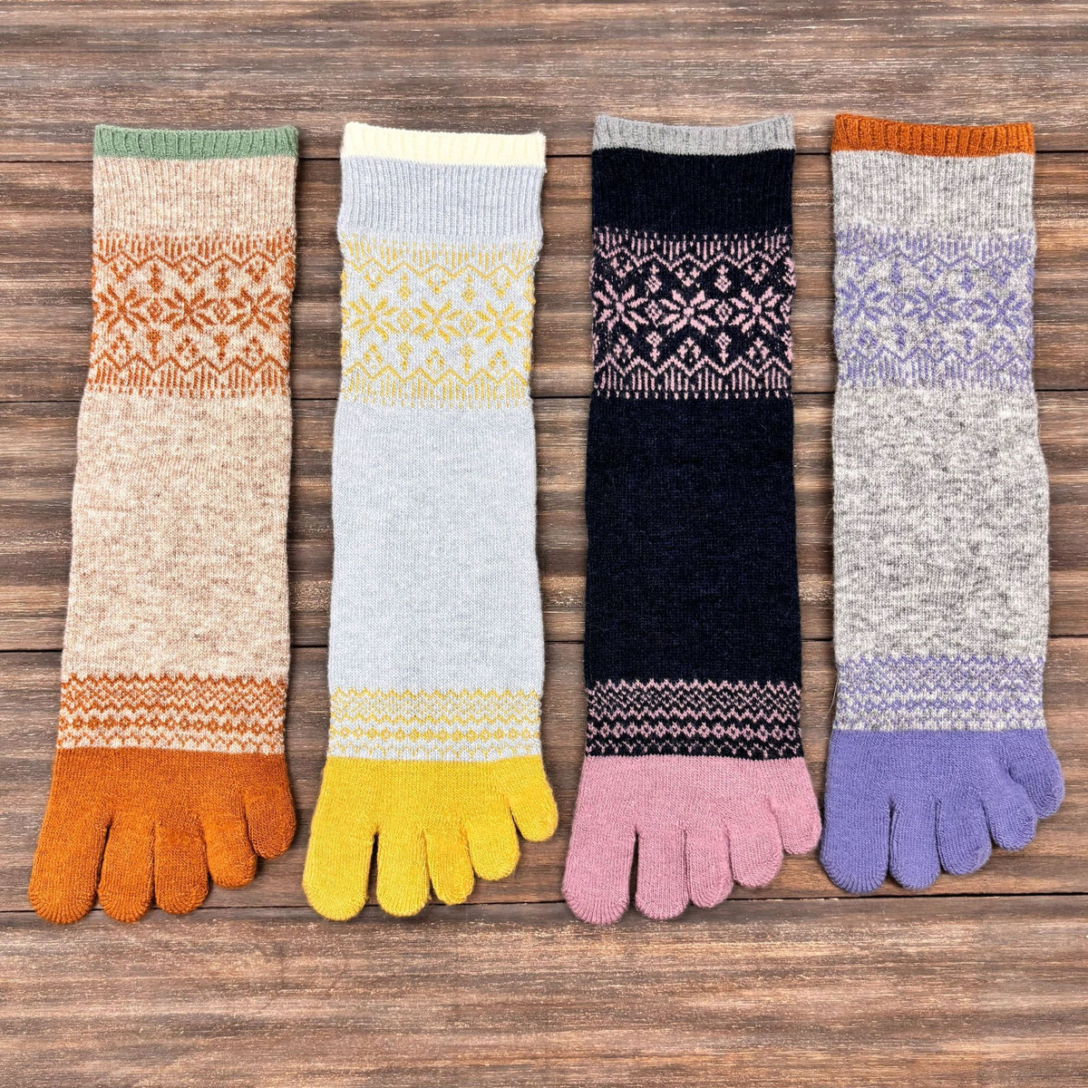 Set of colorful five toe socks on a wooden surface