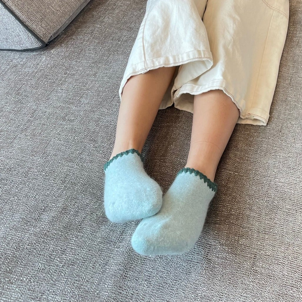 Women wearing - Handcrafted Angora Slipper Socks Grips Medium. Aqua, Light Blue with Green colored trim. Blend with Merino Wool. Size: Medium (US women's shoe size: 5 - 9)
-CHERRYSTONEstyle